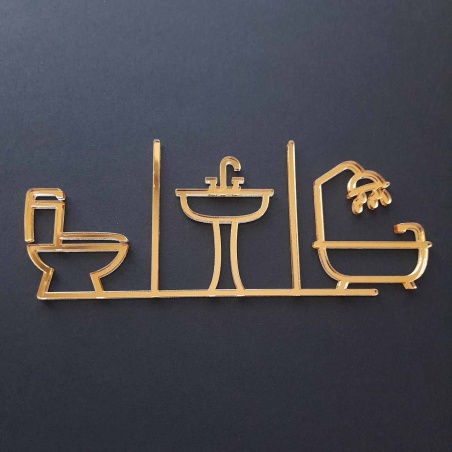 Piktogram na označenie dverí zložený zo symbolu WC, umývadla a kúpeľne vyrezávaný laserom zo zlatého zrkadlového plexiskla