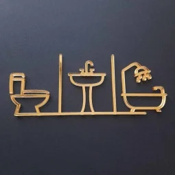 Piktogram na označenie dverí zložený zo symbolu WC, umývadla a kúpeľne vyrezávaný laserom zo zlatého zrkadlového plexiskla